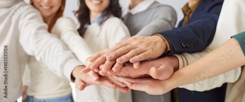Friends team, corporate group office winners join hands to give high five together close up, success gesture, startup triumph, victory, teambuilding to increase motivation and promote cooperation