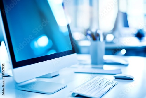 Modern Office Workspace Featuring Computer Monitor Keyboard And Mouse With Cool Blue Tones