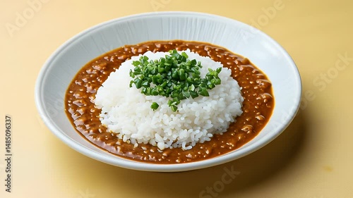 Savory Curry Rice with Green Onions Garnish in White Bowl on Plate Delicious Dish to Savor and Enjoy