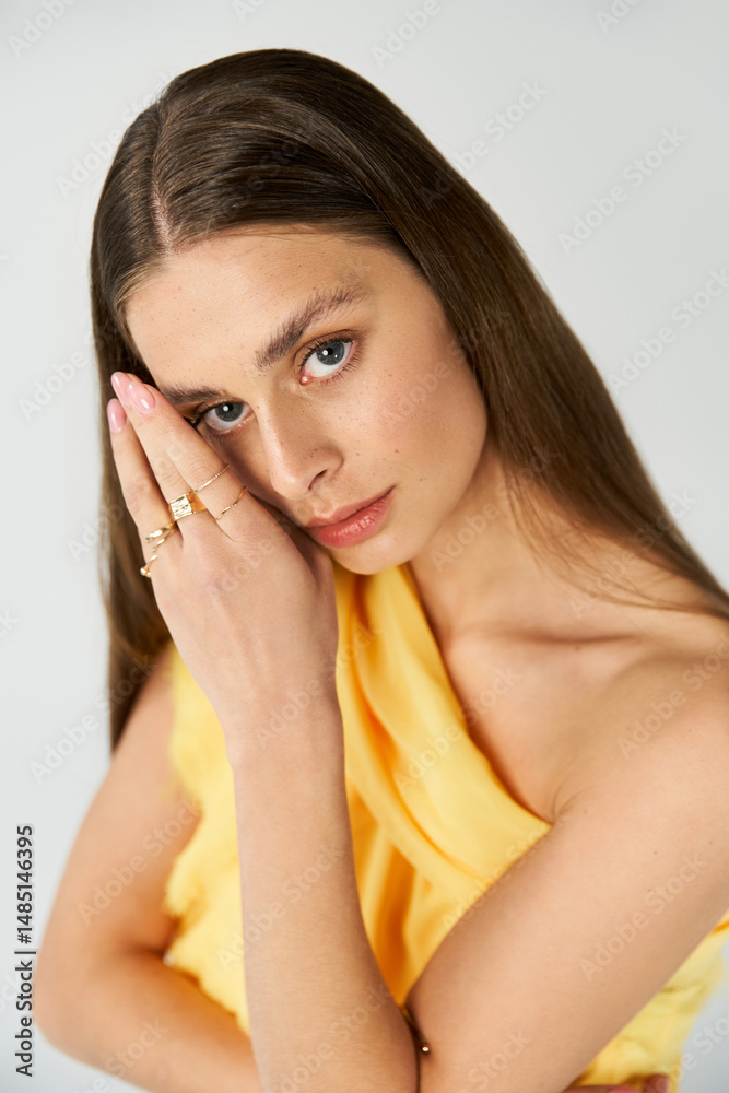 Fototapeta premium Elegant summer fashion showcasing a beautiful woman with a captivating expression and graceful pose