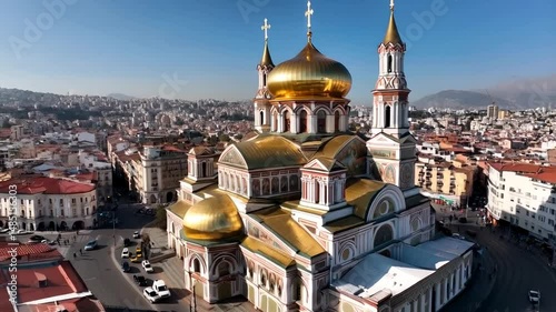 Aerial view of a stunning orthodox cathedral with golden domes in an urban environment