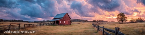 Sunset Over Red Barn in Rural Landscape With Golden Grass and Dramatic Clouds