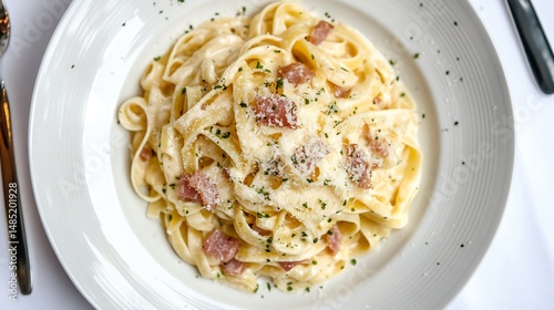Italian Pasta Carbonara white ceramic plate top down view clean white background creamy sauce pancetta Parmesan cheese ideal food blogs or restaurant menus cut out on isolated transparent background