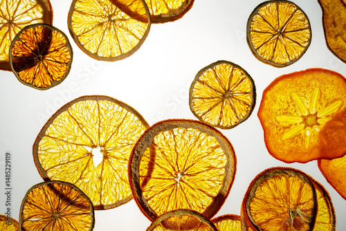 Assorted sunlit slices of dried fruits against a bright backdrop