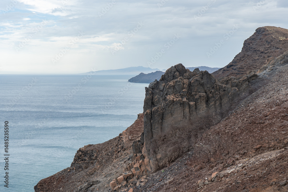 Stunning coastal view of Fuerteventura showcasing rugged cliffs and calm waters Stunning coastal view of Fuerteventura showcasing rugged cliffs and calm waters