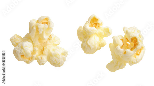Three pieces of popped popcorn isolated on black background with buttery texture visible closely on transparent background