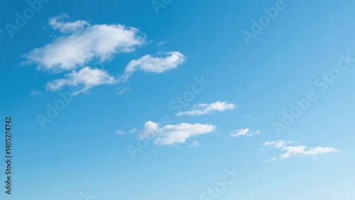 Vast blue sky with scattered clouds, a serene minimalist canvas of endless calm