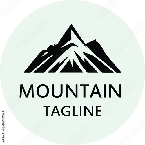Mountain logo design with tagline in a circle. Simple, minimalist mountain silhouette with the text "MOUNTAIN" and "TAGLINE" layered over it.