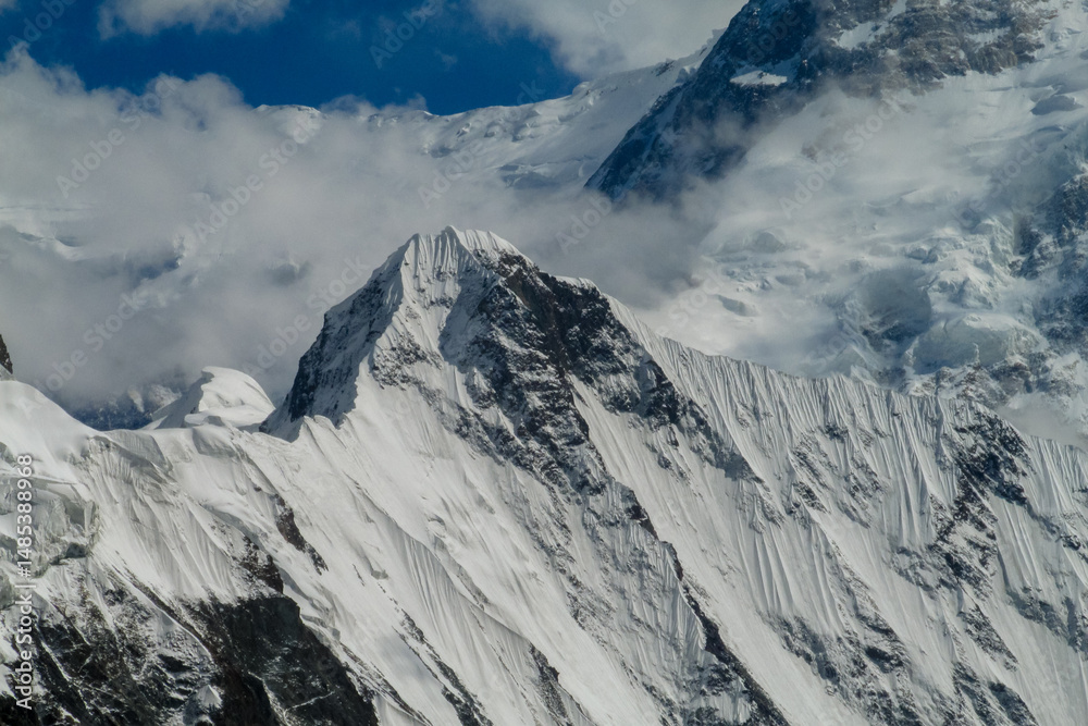 Obraz premium Tian Shan mountains snow peaks and steep slopes in Kazakhstan and Kyrgyzstan border with China. South Inylchek glacier, Enilchek Khan Tengri and Pobeda Victory peak base camp in Pamir mountain range