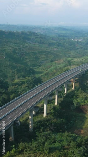 4K Vertical Drone Video of Tropical Mountain Highway Traffic with Bridge 