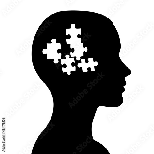 Silhouette of a head with puzzle pieces representing thought process  