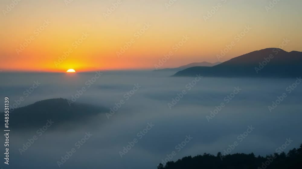 time lapse foggy or mountains tops over clouds sunrise sky. A sea of fog is formed from stratus. Foggy valley mount ridge nature. Time lapse Beautiful foggy and cloudy slow moving Aerial