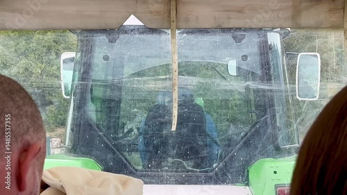Scenic ride to Lipa cave by tractor-pulled tourist vehicle on a rainy mountain day photo