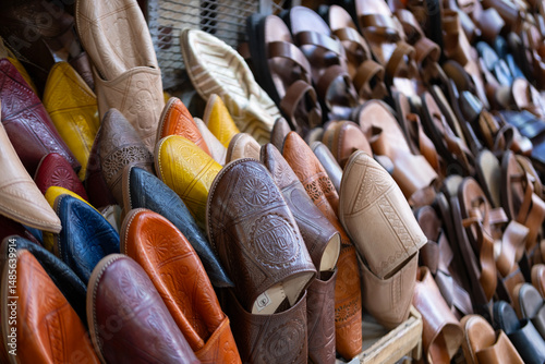 Colorful Vibrant leather handmade Moroccan slippers, babouches for sale in traditional local souk, story heritage and authentic oriental craftsmanship, artisanal culture Morocco