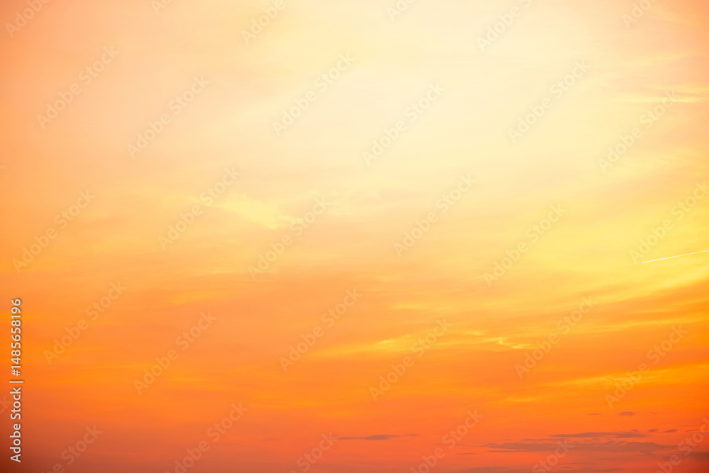 Obraz premium Sky,sunset, beautiful , luxury soft gradient orange gold clouds and sunlight on the blue sky perfect for the background, Sunrise on morning or everning in winter warm time ,Twilight summer,silhouette