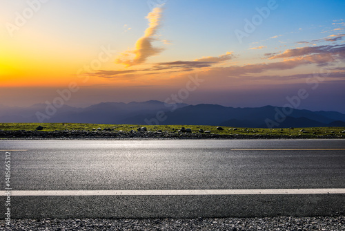 Empty asphalt road and mountain with beautiful sky clouds at sunset