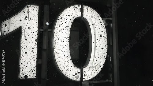 A weathered number ten painted on a rough surface in close-up, showing industrial texture and urban art concepts used in designs, signs or creative backdrops