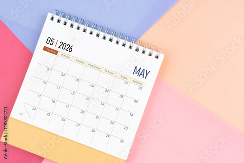 May 2026 month desk calendar on colorful background.