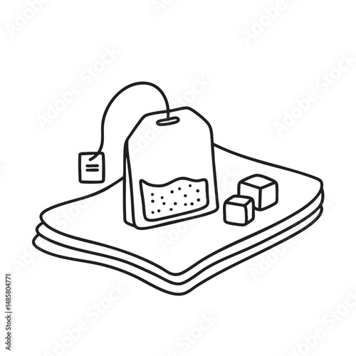 A tea bag placed on a napkin beside sugar cubes