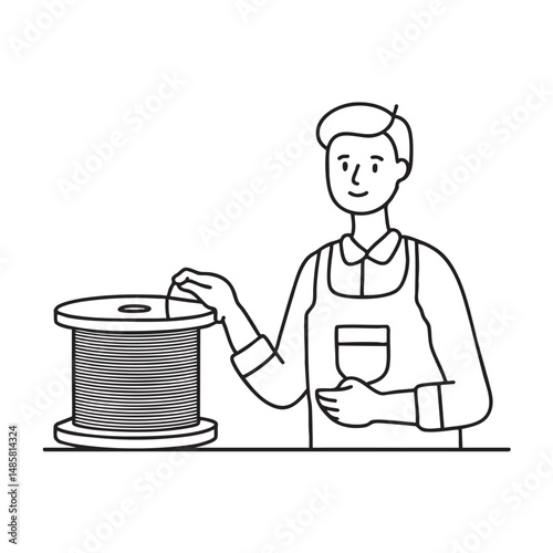 Male technician labeling cables beside a spool of wire