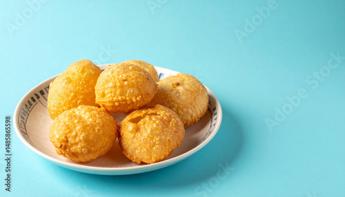 Pani Puri Indian Street Food Isolated on Light Blue Background with Minimal Design photo