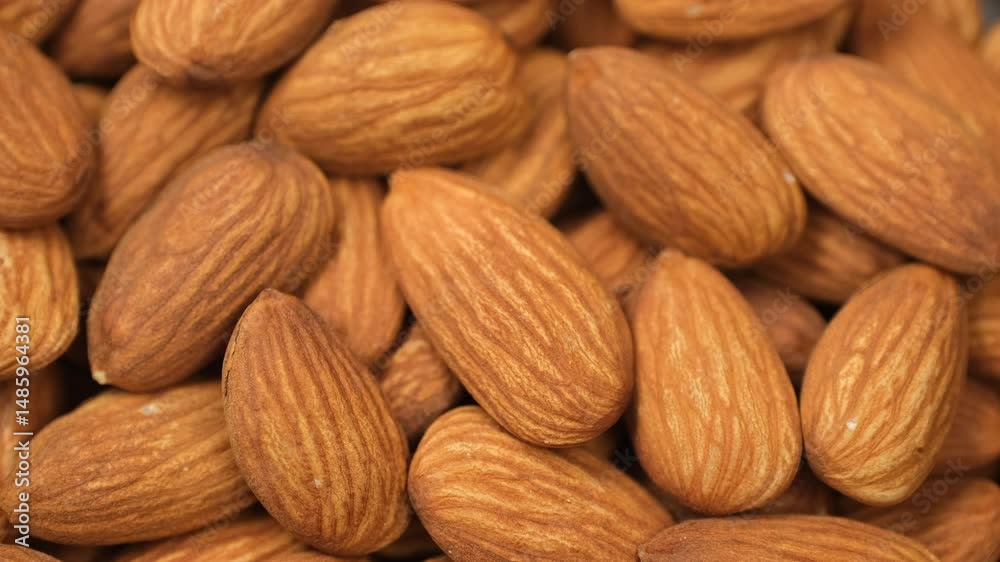 Heap Almonds macro top view, rotation. Whole almond nuts healthy snack Heap Almonds macro top view, rotation. Whole almond nuts healthy snack