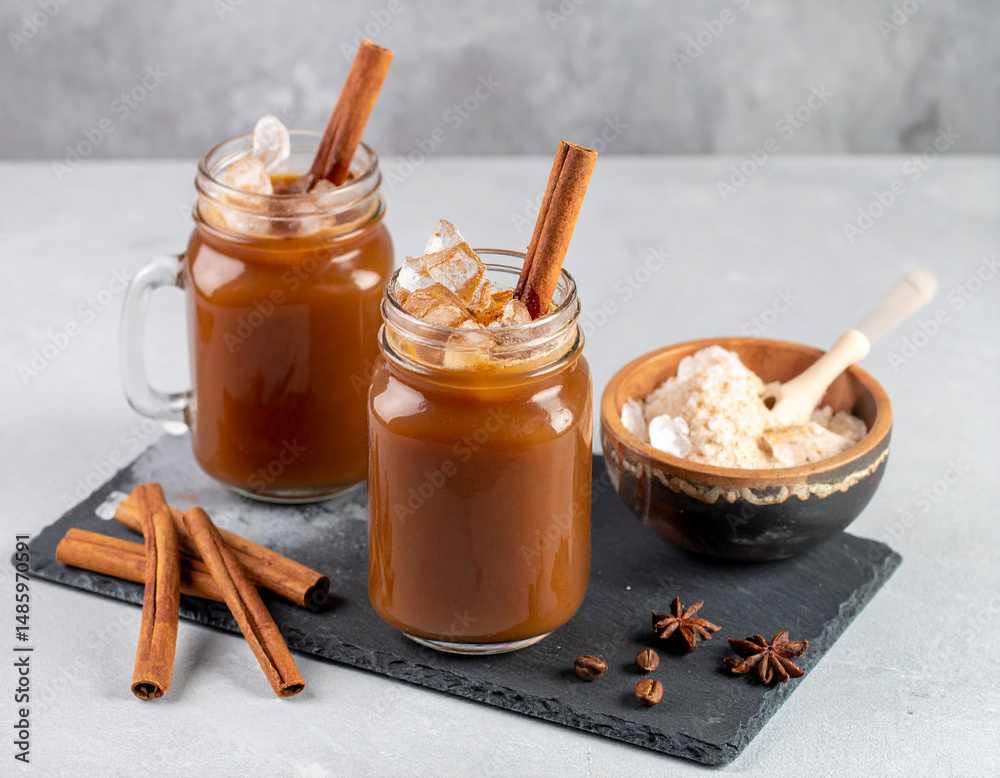 Fototapeta premium Venezuelan chicha drink served in glass jars with cinnamon and crushed ice
