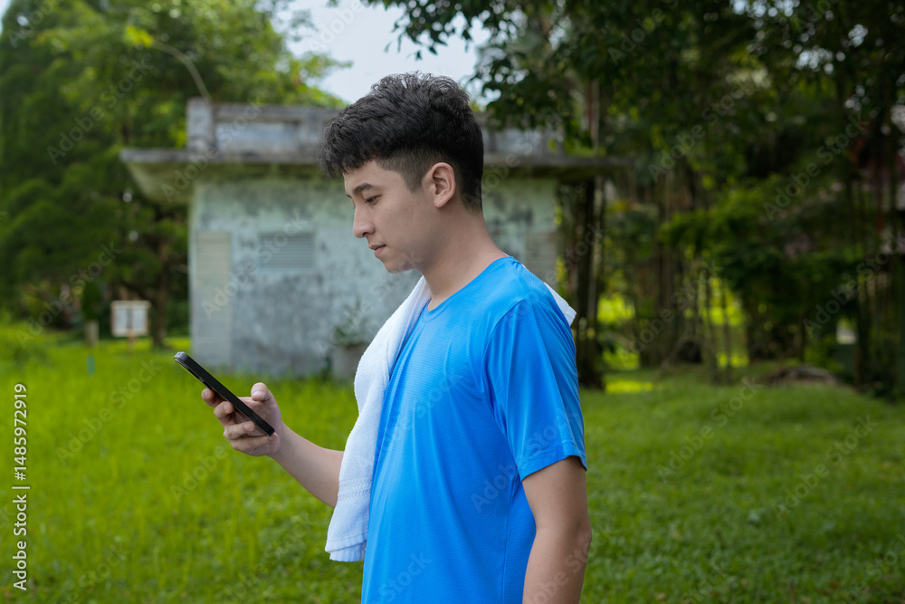 young man using smartphone outdoors in casual attire under daylight young man using smartphone outdoors in casual attire under daylight