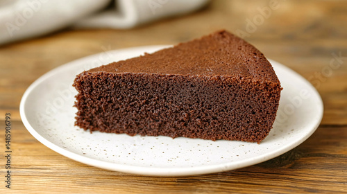 A delightful slice of chocolate cake, ready for a perfect dessert on a wooden table.