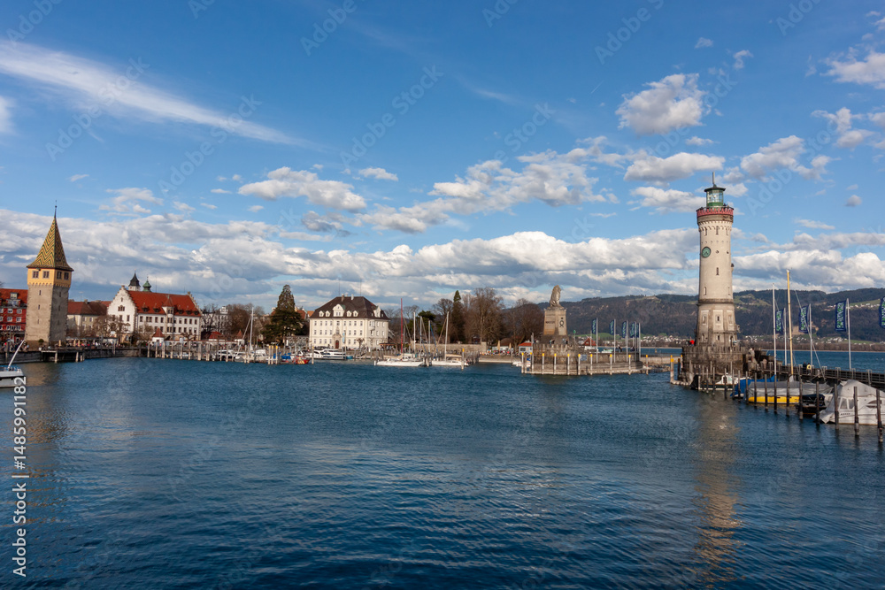 Fototapeta premium This scenic wide-angle shot captures the entrance to the harbor of Lindau, a charming island town on Lake Constance (Bodensee)