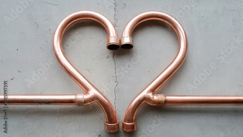 Copper pipes arranged in a heart shape, symbolizing love and connection in infrastructure