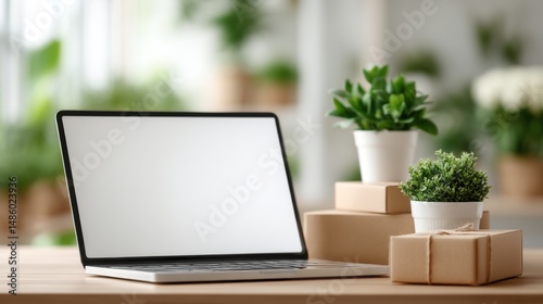 Modern Laptop Workspace with Plants and Gifts photo
