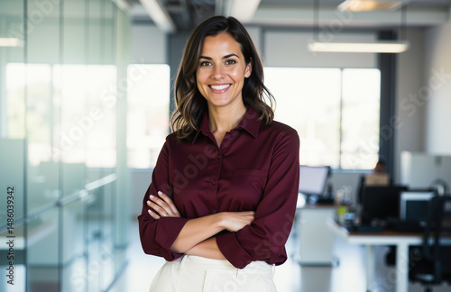 Confident woman in maroon shirt in modern office