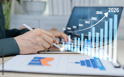 Obraz na plátně Business goals for businessmen 2026, positive indicators of the company's global competitiveness, businessmen calculate financial data for long-term investments