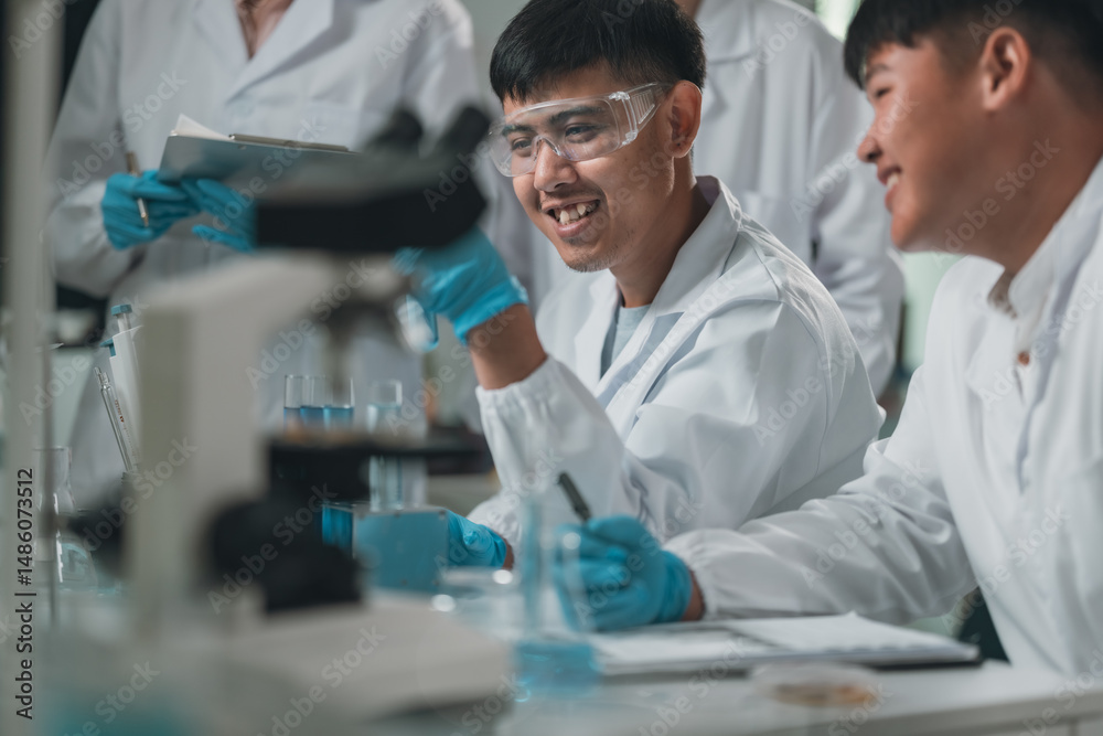 Fototapeta premium Medical research team conducting scientific experiments in a pharmaceutical laboratory, analyzing samples under microscopes to develop innovative medicine and healthcare solutions