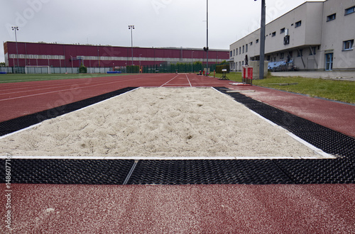 Sand landing field for athletics. Long jump. Traditional athletics discipline. Long jump, triple jump, Technical power athletics discipline. Athletics outdoor stadium.