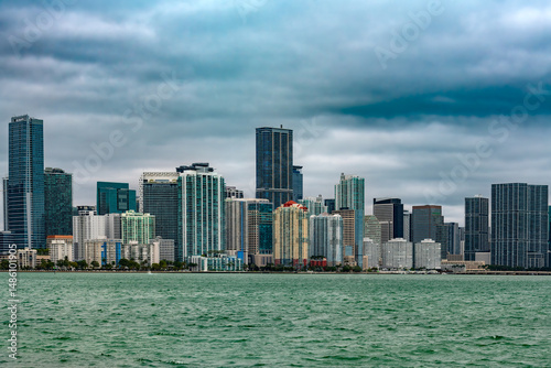 The skyline of downtown Miami showcases a dynamic mix of sleek office towers and modern apartment buildings, rising above the city in a display of contemporary architecture and urban energy.