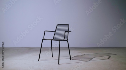 A comfortable white chair and table furnish the interior of a room, suggesting an office or home design with empty space