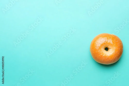 Wallpaper Mural Plain glazed bagel on teal background Torontodigital.ca