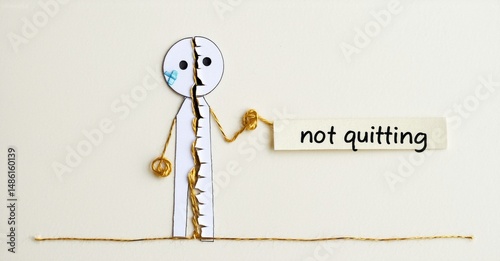 Paper doll split, stitched together. Message reads not quitting. Symbolizes resilience, perseverance, hope, determination. Simple, clean aesthetic.