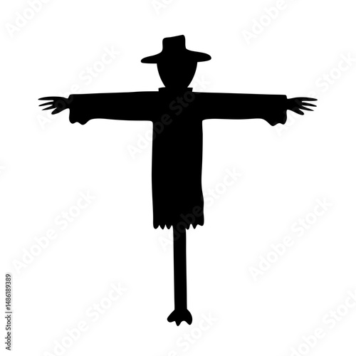 Silhouette of a scarecrow standing tall and watching over the field