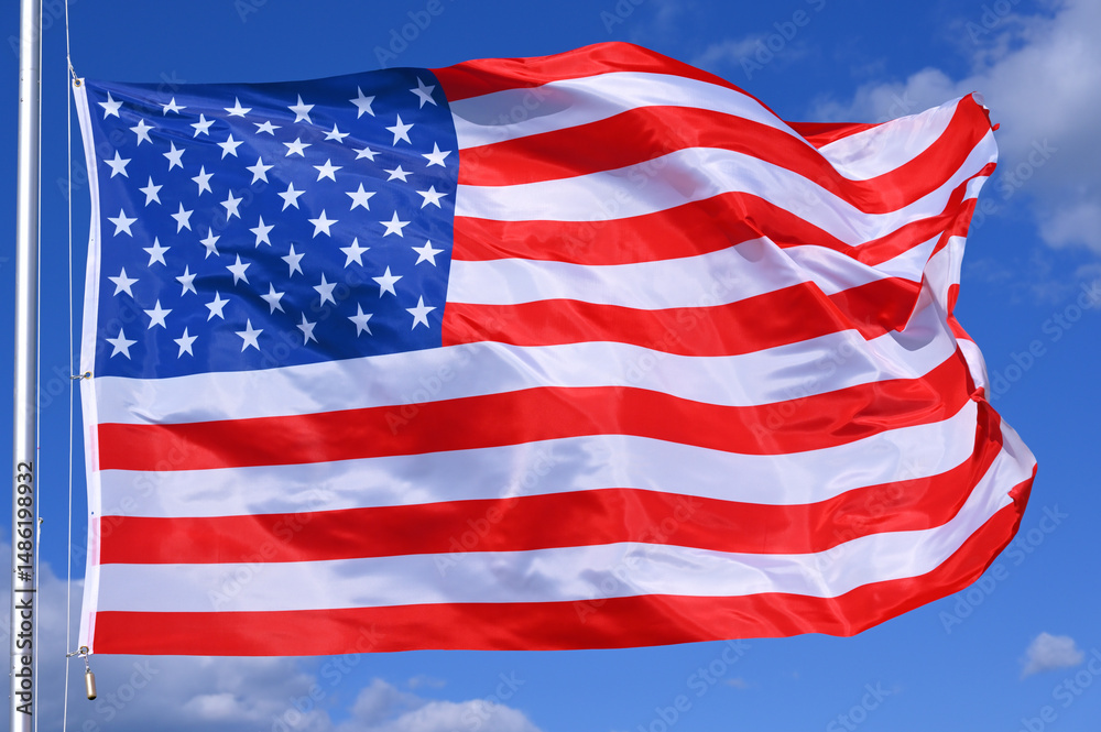 Fototapeta premium Close-up of the national flag of United States fluttering in the wind, wave pattern