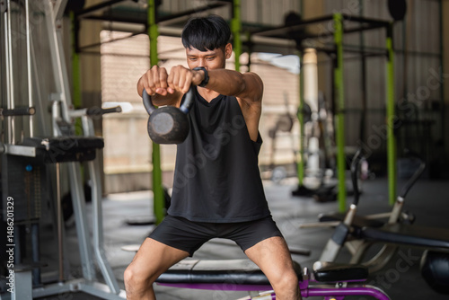 Kettlebell Workout. Man lifting kettlebell in gym for functional fitness and strength.
