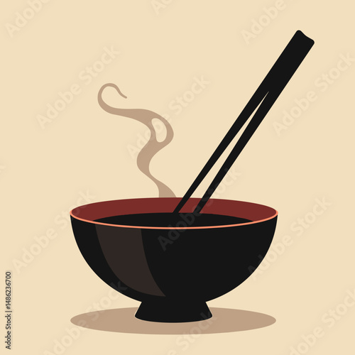 Traditional bowl of steaming soup with chopsticks on beige background  