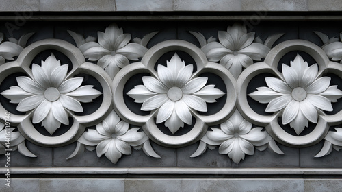 Intricate plasterwork floral design in a repeating pattern creates a decorative architectural element, showcasing craftsmanship and refined artistic expression.