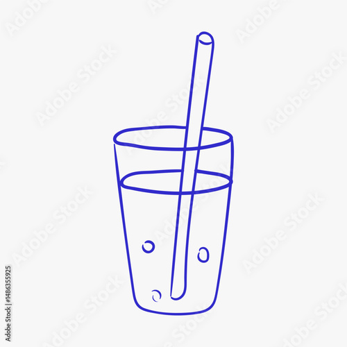 Classic glass filled with refreshing beverage and straw showcases simplicity of drinkware design