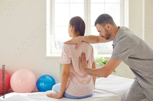 Manual therapy back spinal injury rehabilitation, physical therapist manipulative therapy in medical clinic room. Chiropractor or physiotherapist helping patient with scoliosis, pain, spine problems