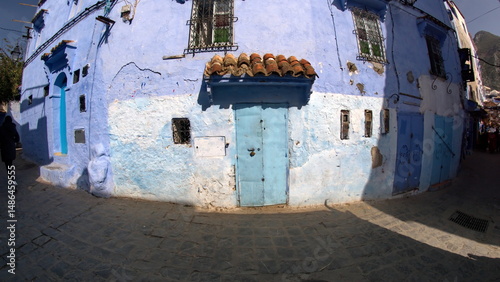 Tiled canopy over a blue door in the medina, in Chefchaouen, Morocco