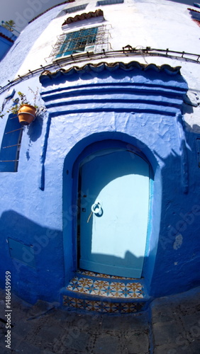 Blue door with an arched top in the medina, in Chefchaouen, Morocco, taken with a fisheye lens