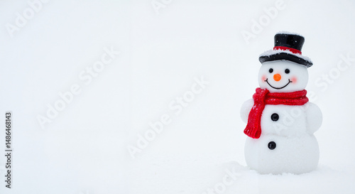 Snowman wearing a black hat and red scarf standing in winter snow, white background, copy space 